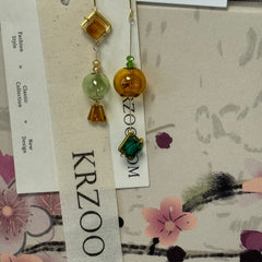 T glass ball asymmetrical long green earrings