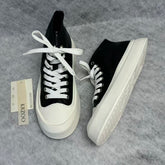 High-top black and white canvas shoes with thick soles