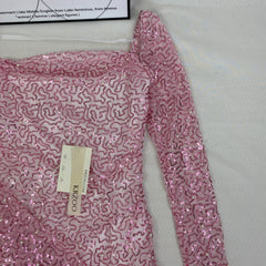 A slimming, soft pink, figure-hugging dress