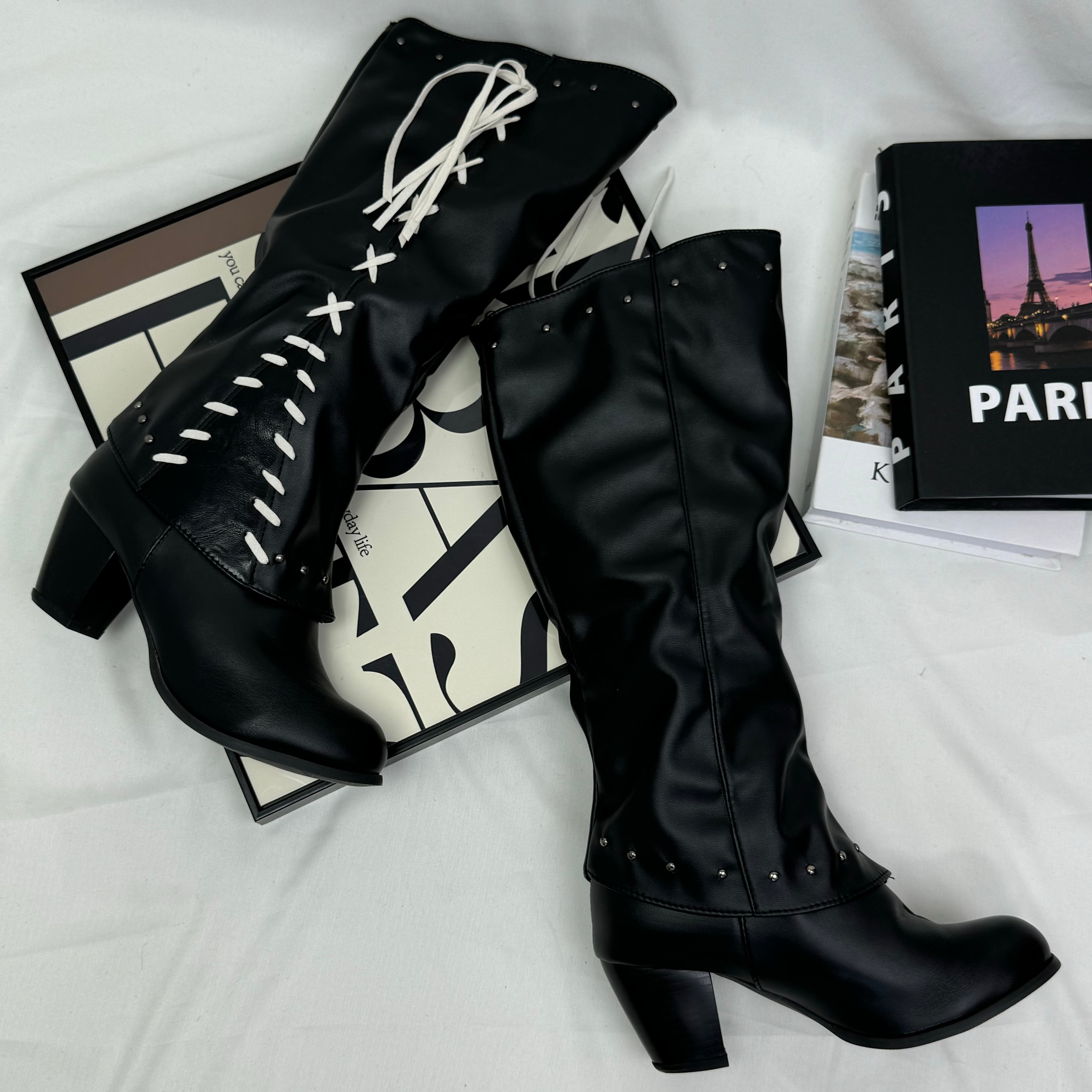Tasseled long boots made of leather