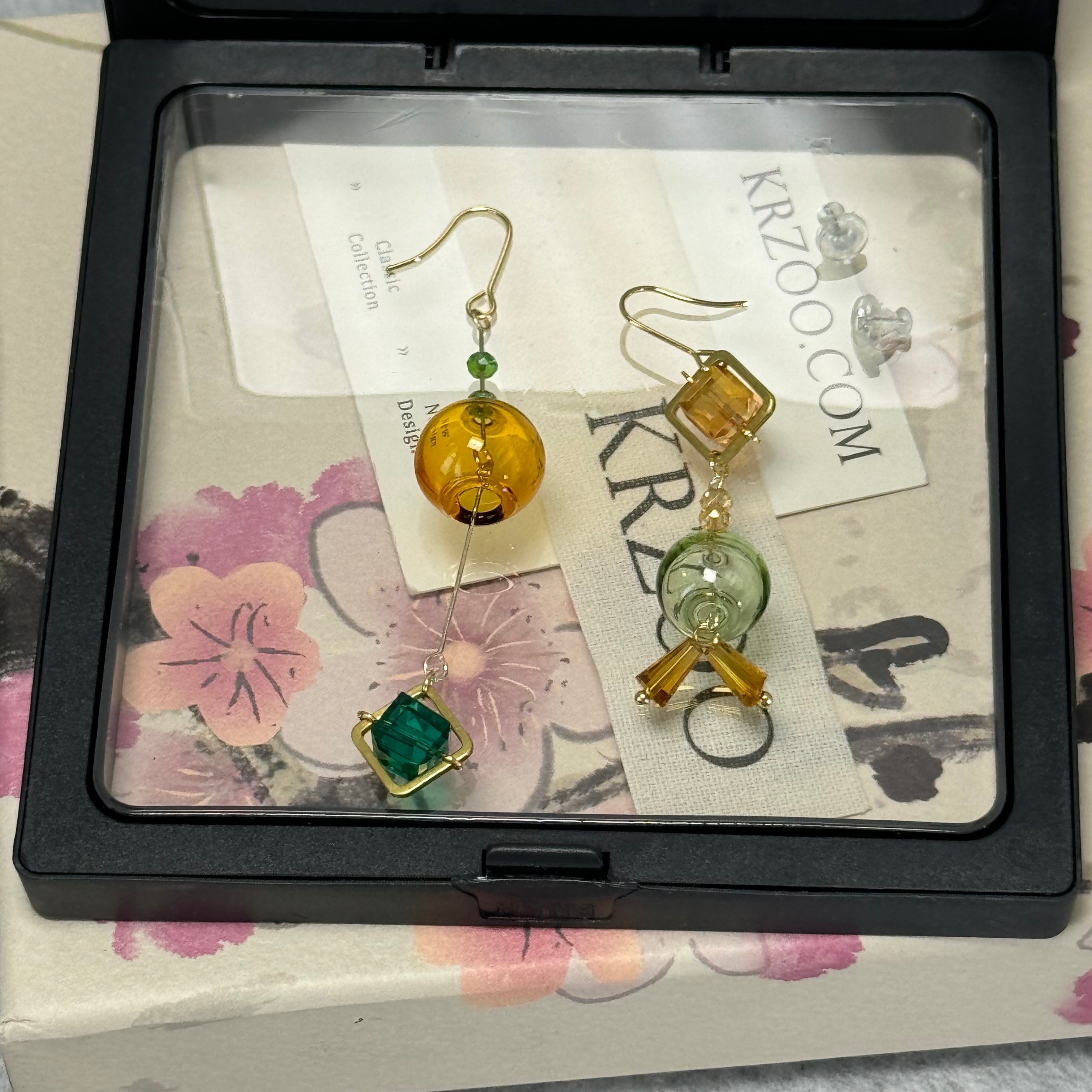 T glass ball asymmetrical long green earrings