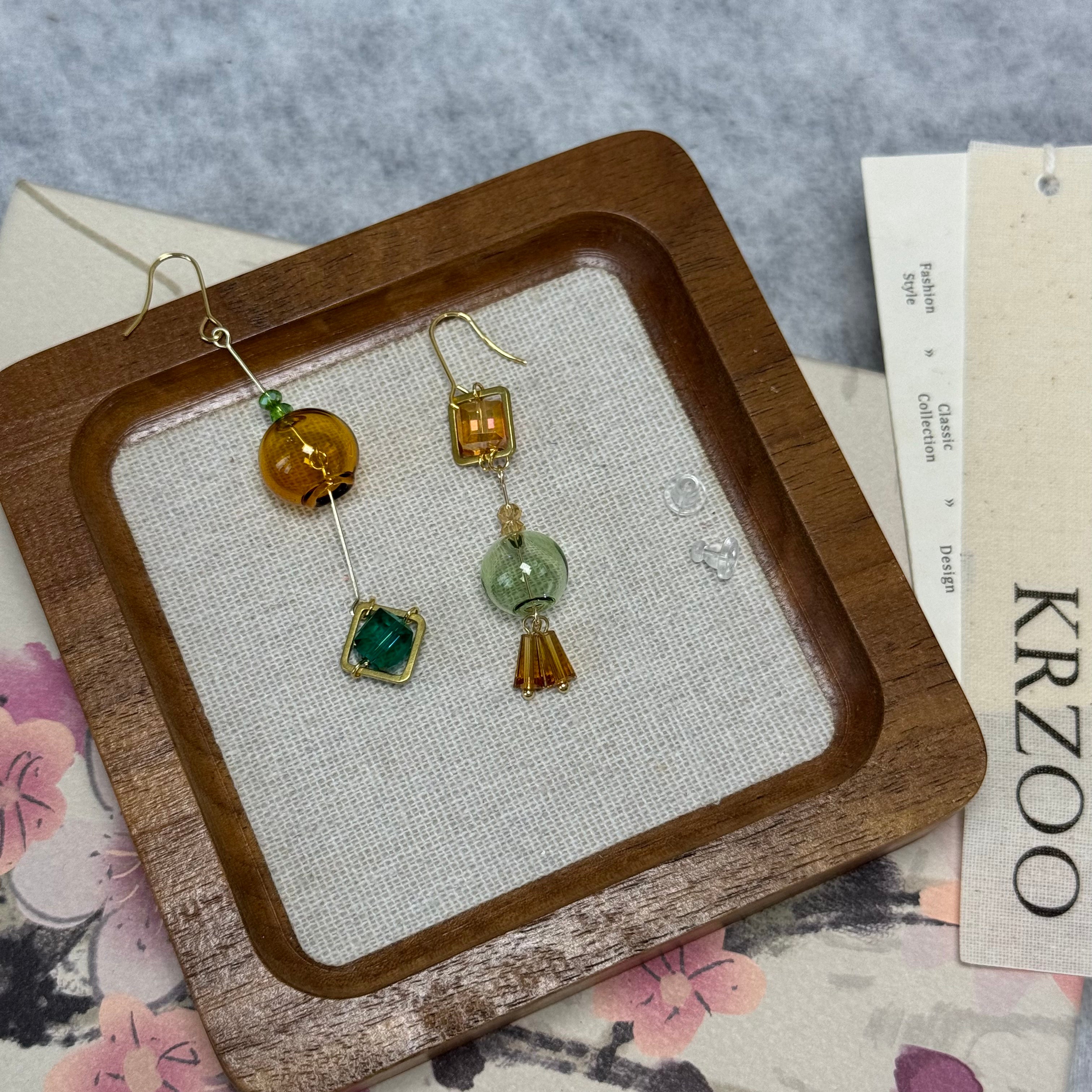 T glass ball asymmetrical long green earrings