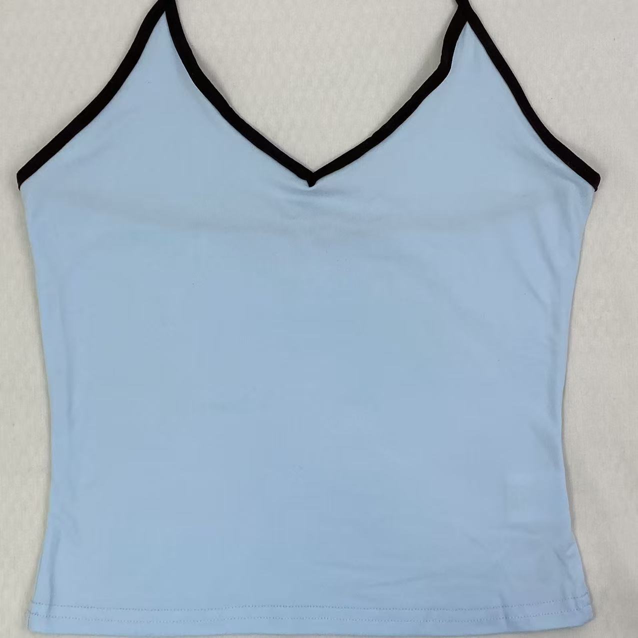 Contrasting color tie-neck sling-neck top