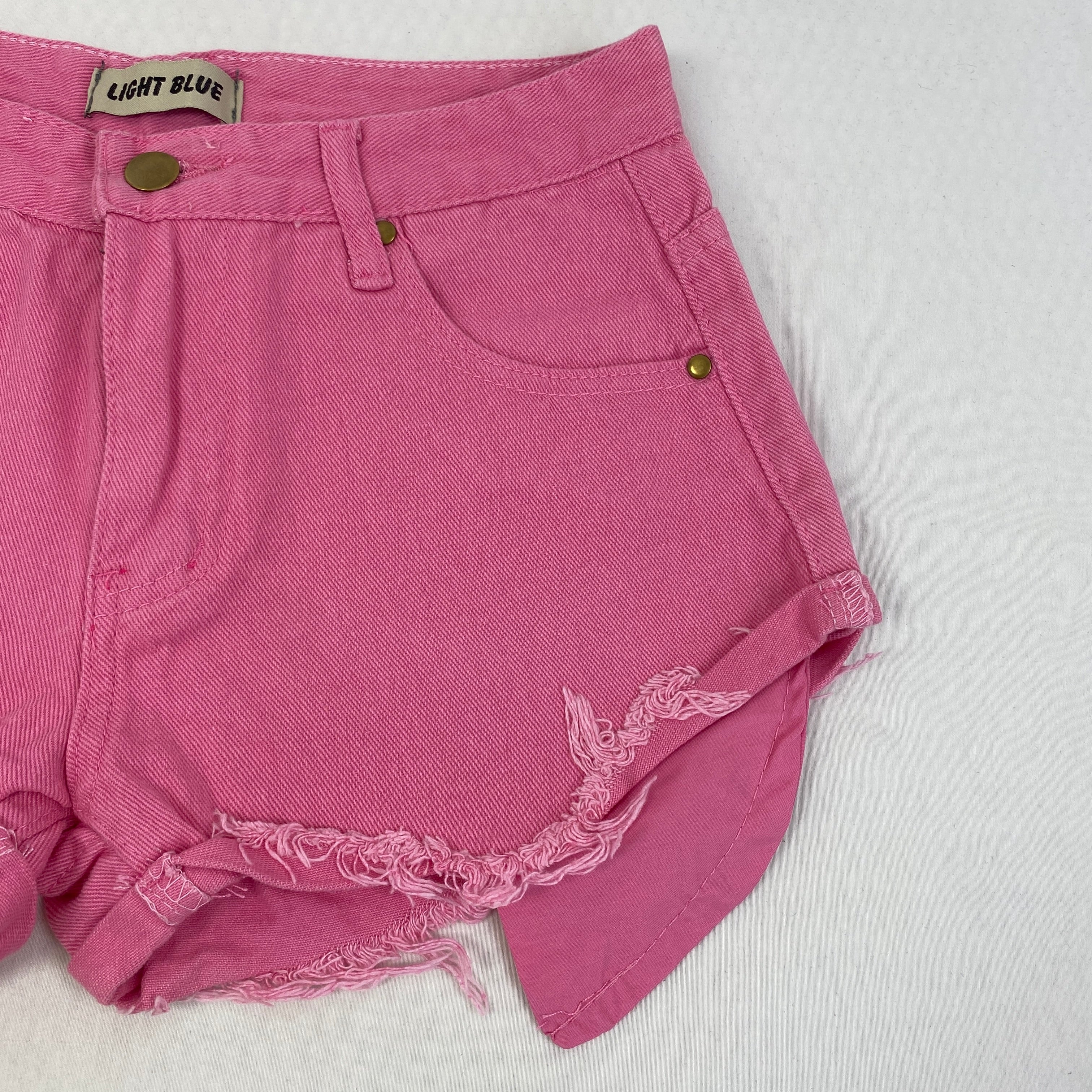 Jeans shorts with rolled hems and exposed pockets