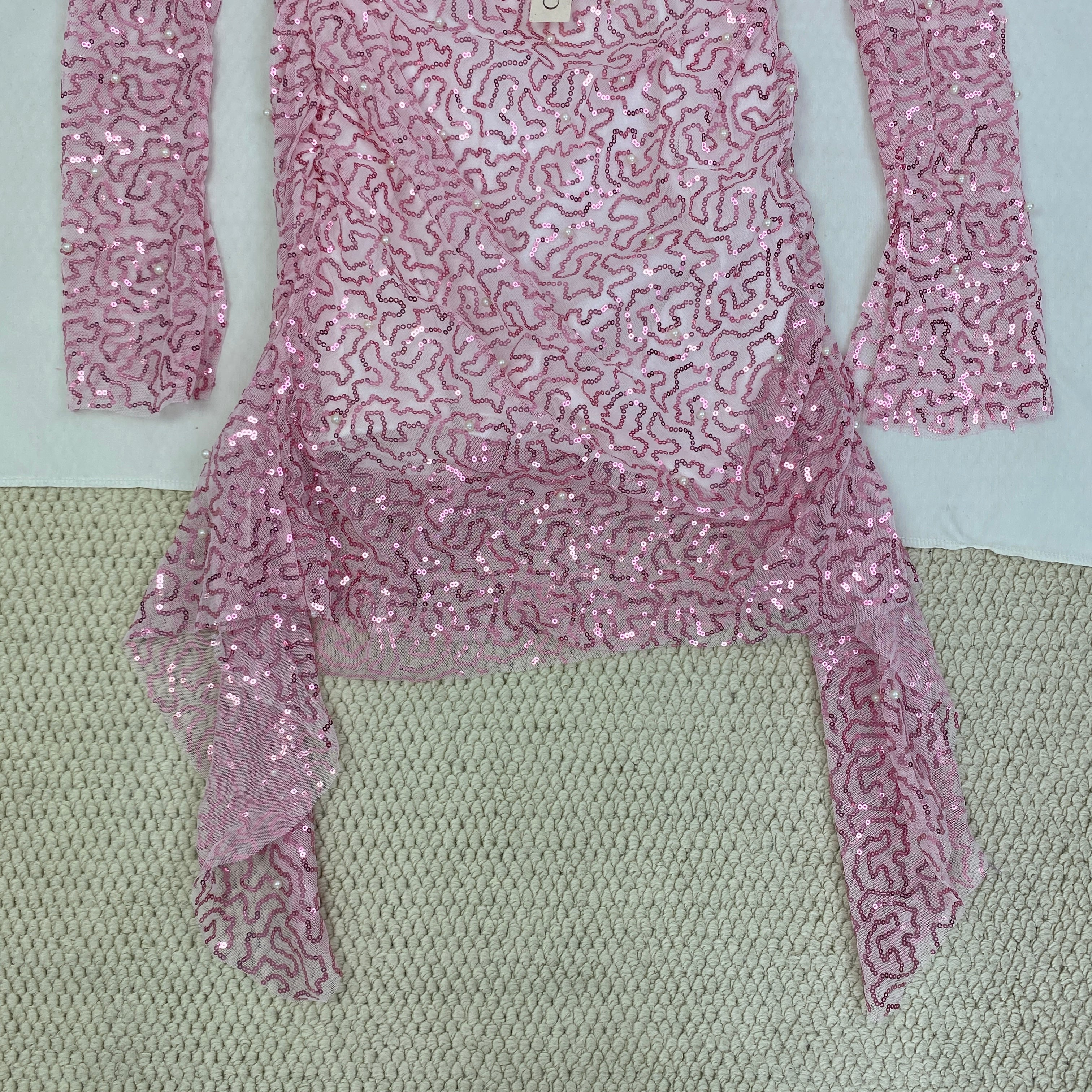 A slimming, soft pink, figure-hugging dress