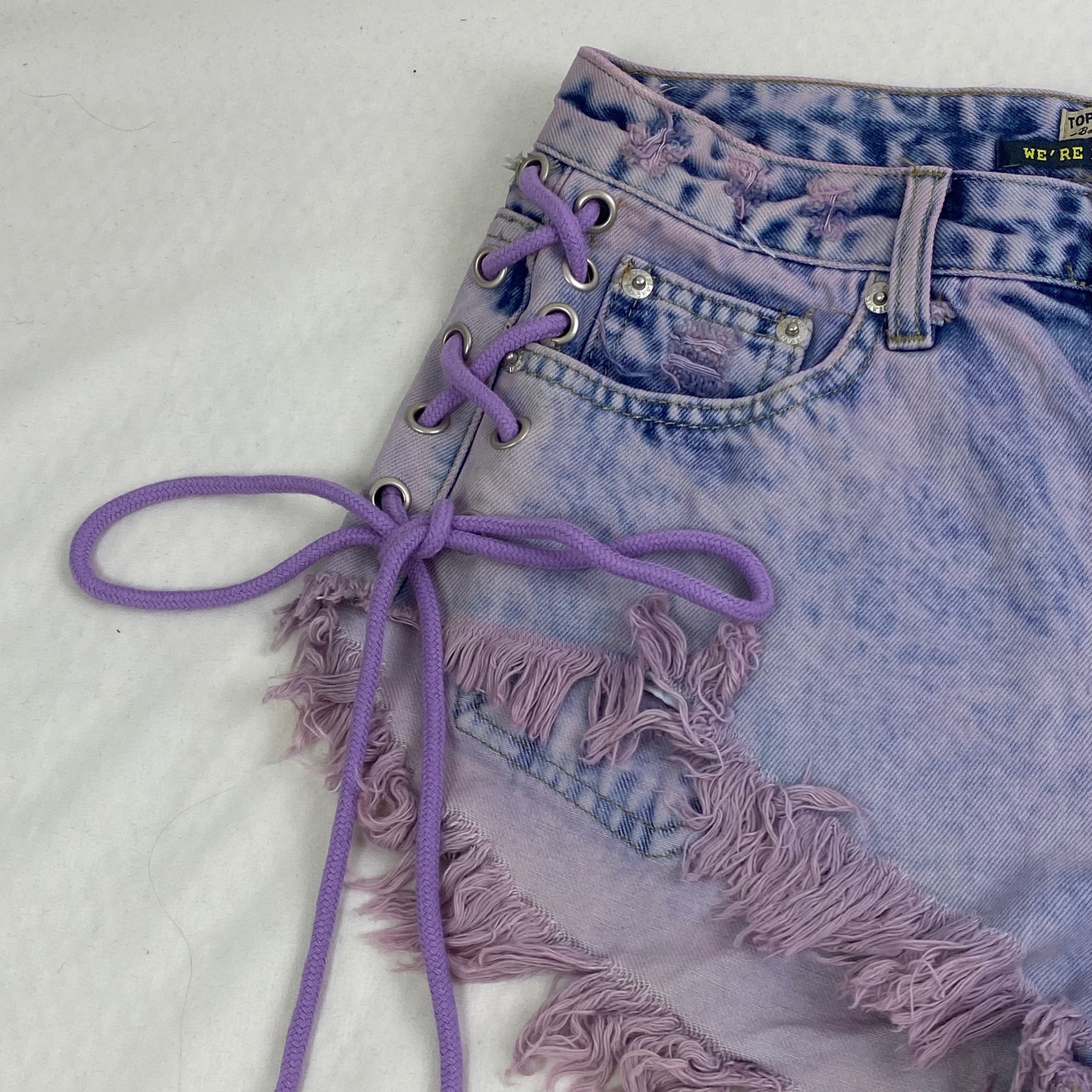 Purple strapped buttoned fringed shorts
