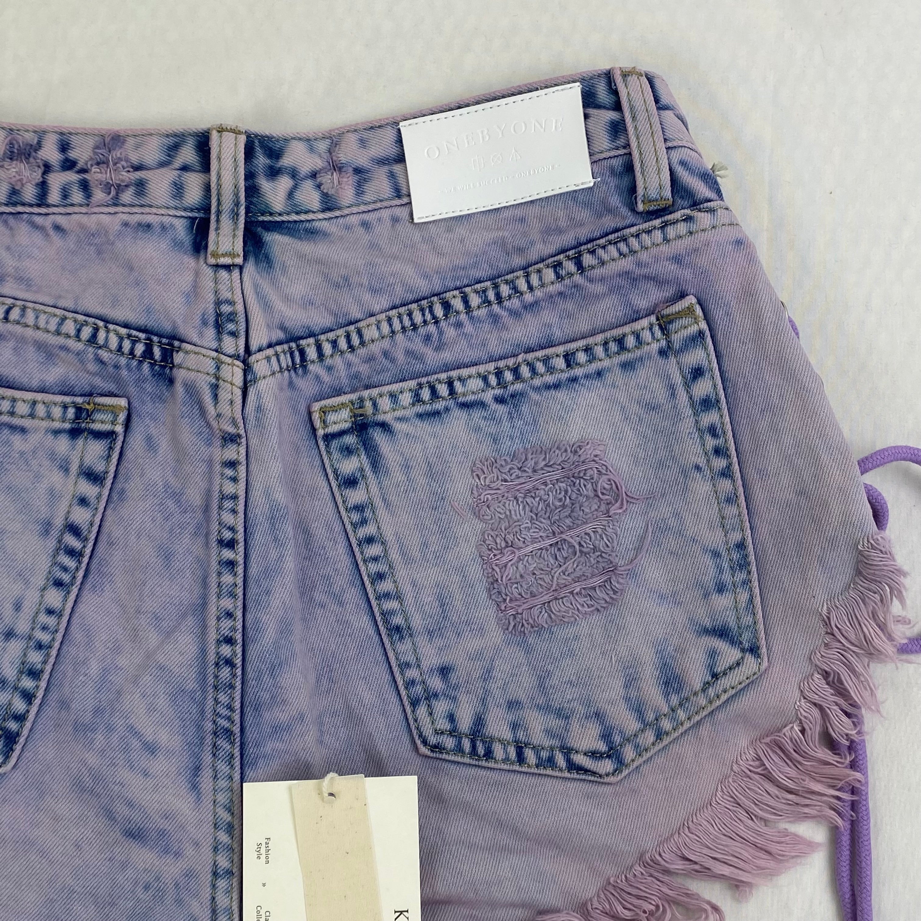 Purple strapped buttoned fringed shorts