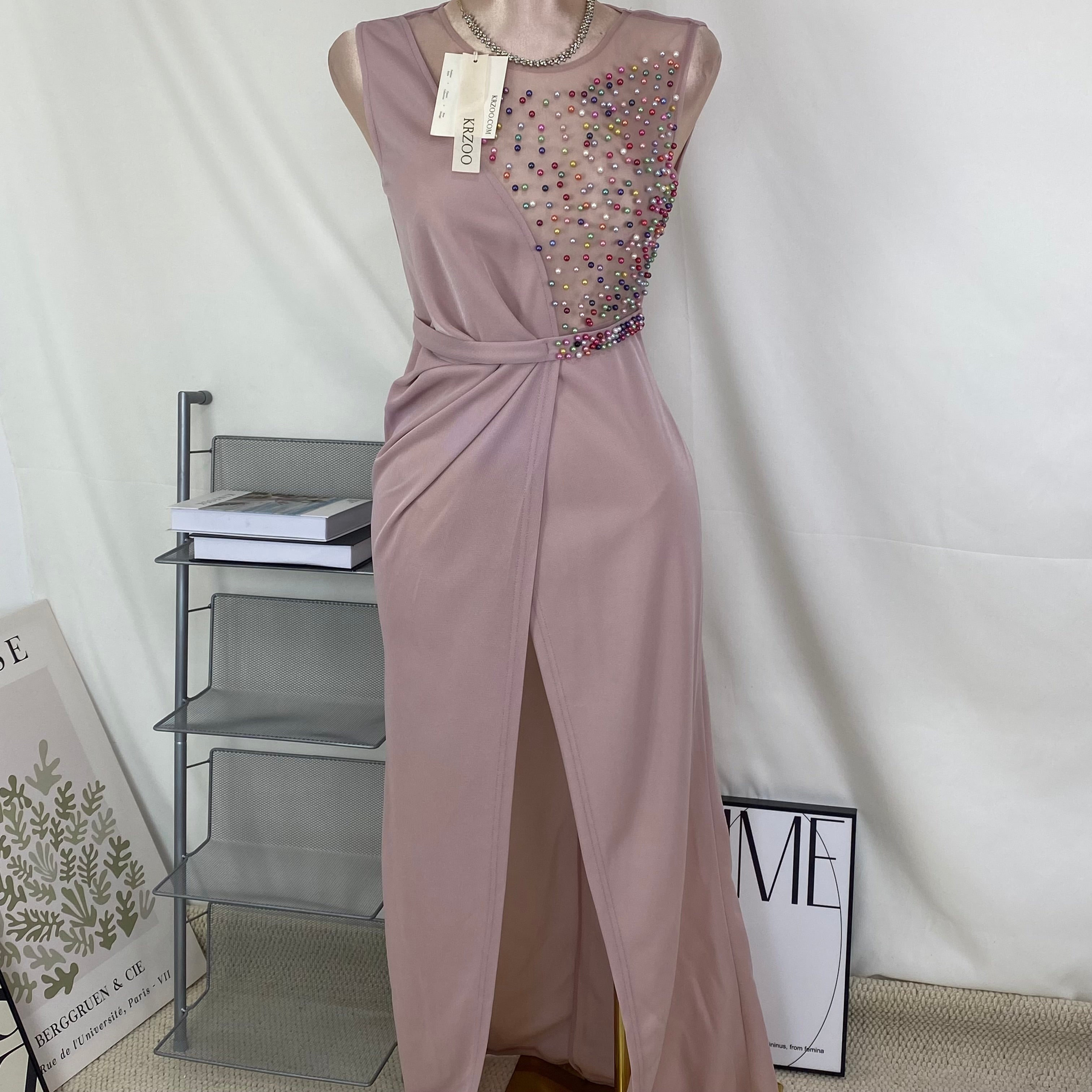 A halter-style and trailing evening dress