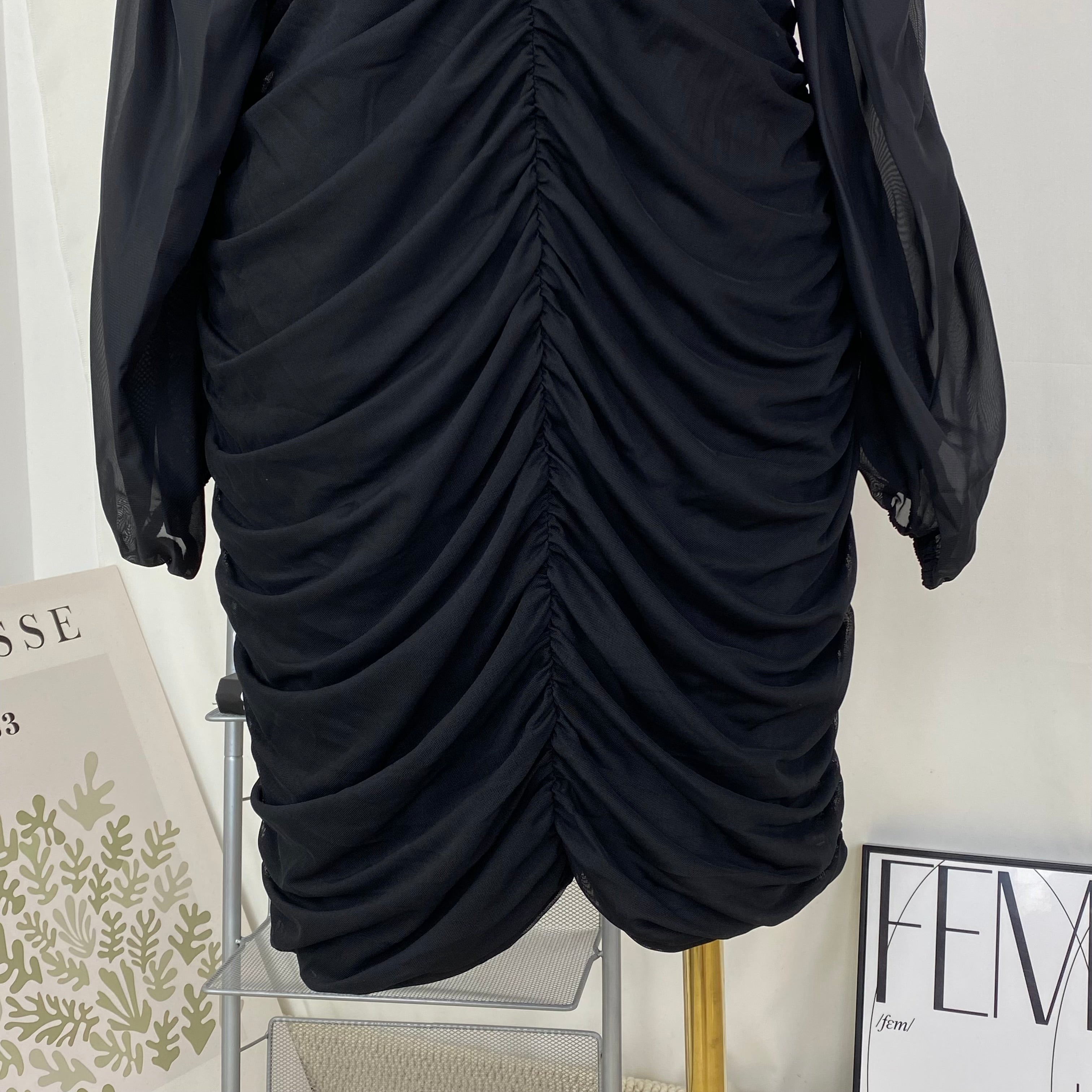 A tight-fitting short dress with a plunging neckline