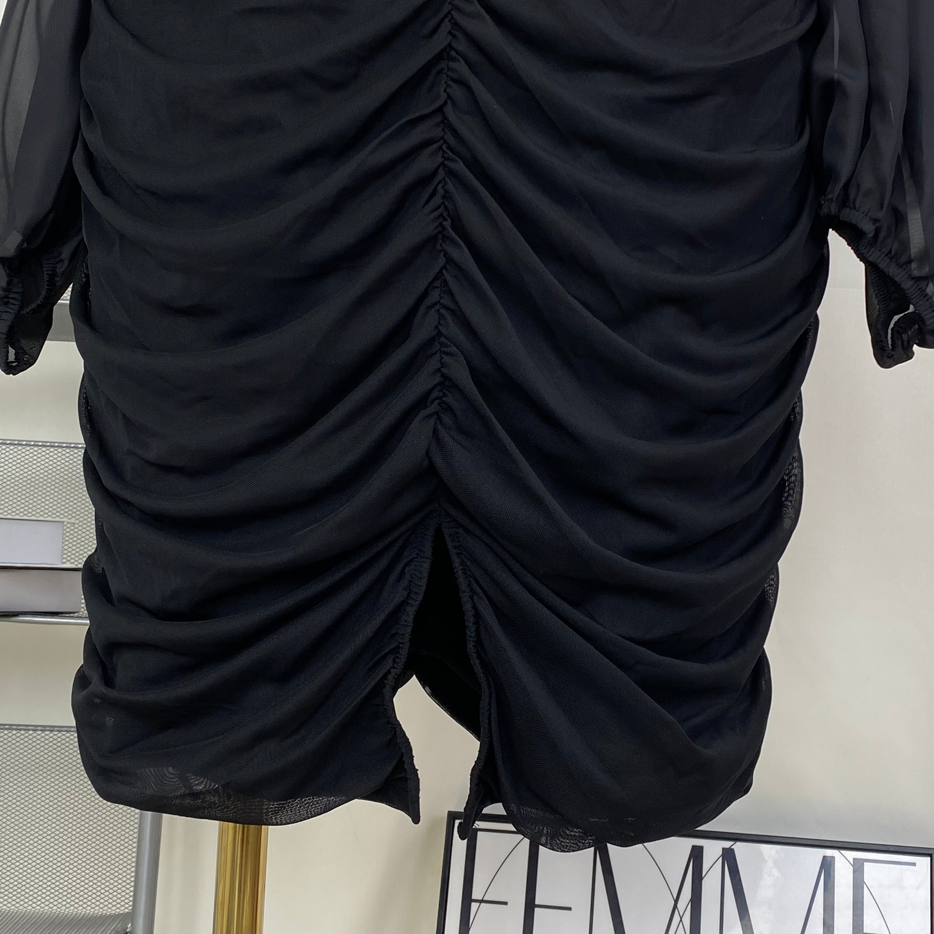 A tight-fitting short dress with a plunging neckline