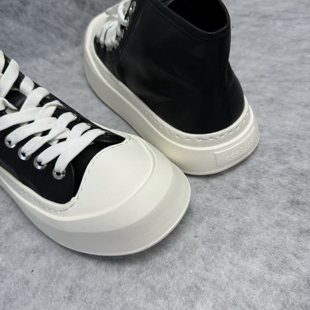 High-top black and white canvas shoes with thick soles