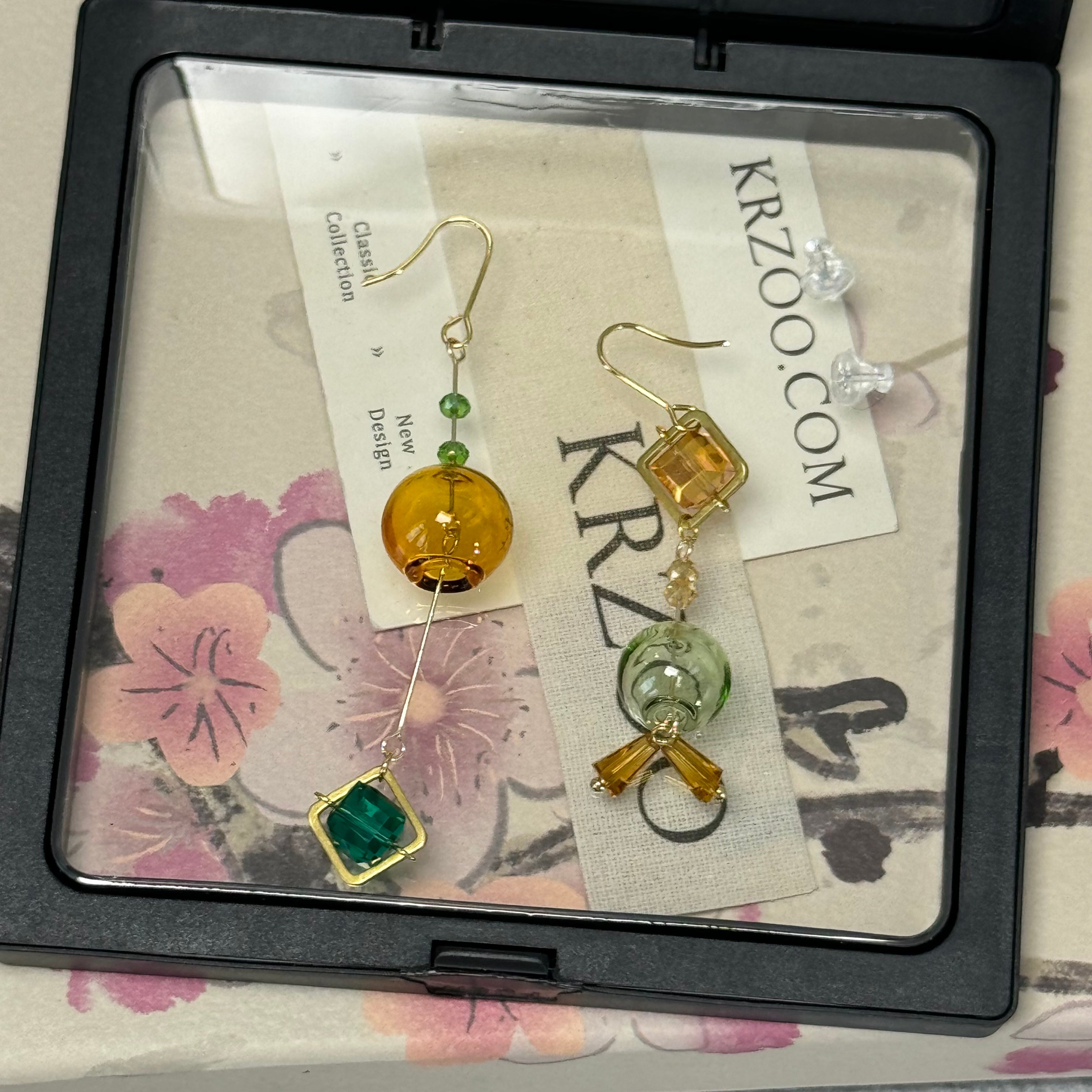 T glass ball asymmetrical long green earrings