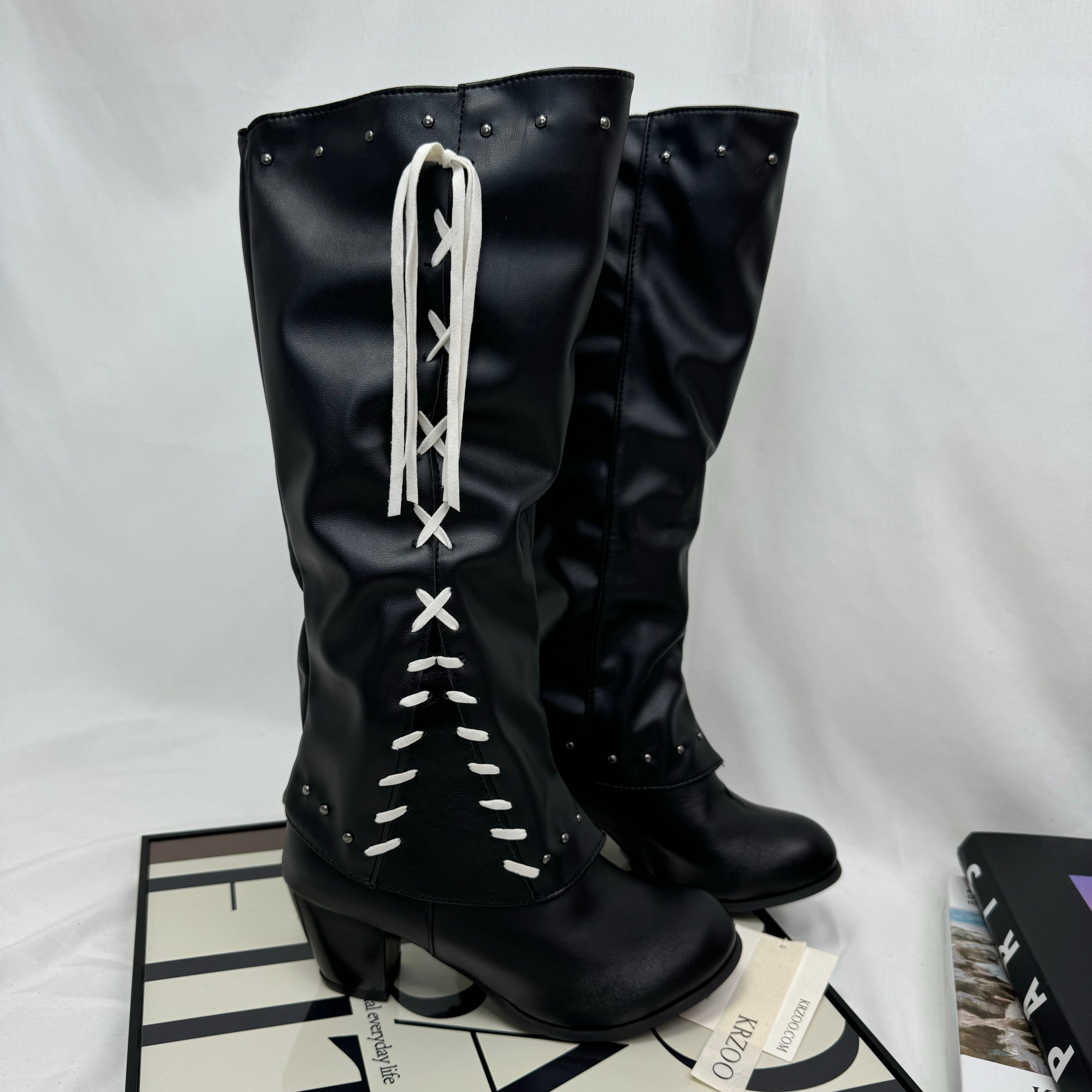 Tasseled long boots made of leather